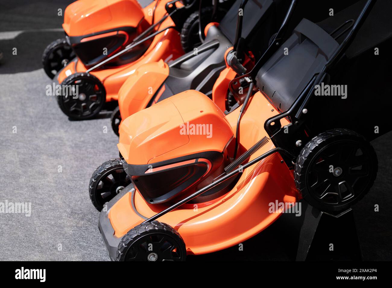 Electric lawn mowers in a row Stock Photo - Alamy