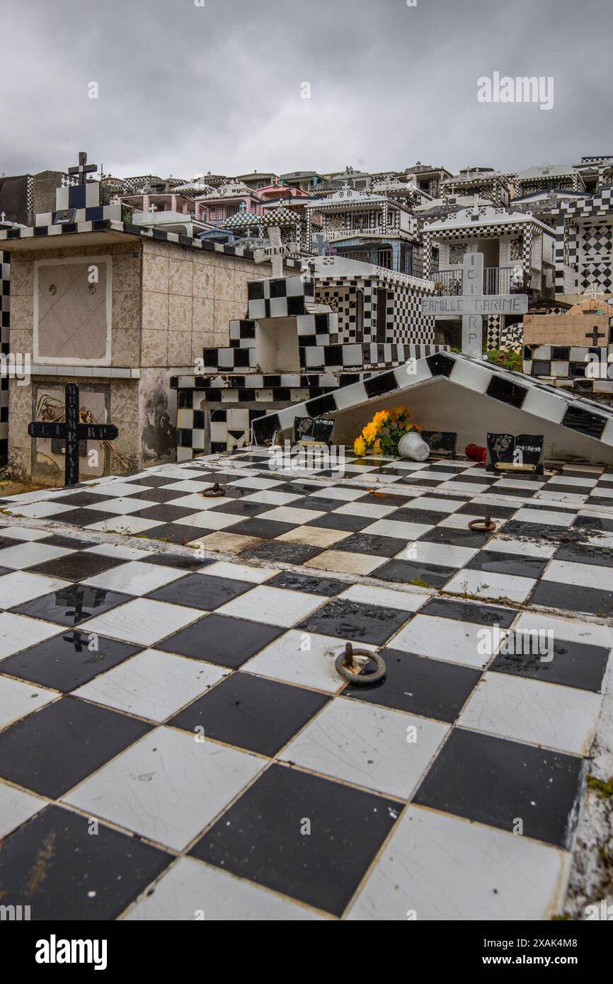 Famous cemetery, many mausoleums or large tombs decorated with tiles, often in black and white. Densely built buildings under a dramatic cloud cover Cimetiere de Morne-a-l'eau, Grand Terre, Guadeloupe, Caribbean Stock Photo