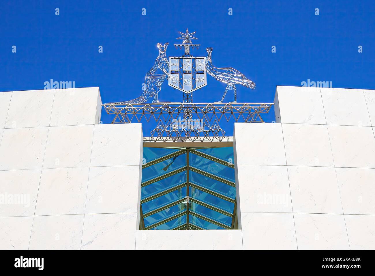 Coat of Arms of Australia featuring a shield held by a kangaroo and an emu under the Commonwealth Star on the facade of the Parliament House of Austra Stock Photo