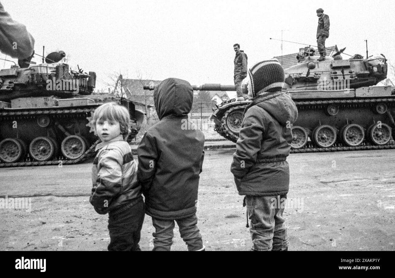 Children watch a tank column, actions of the peace movement against the 'Warsteed' maneuver in March 1984 Stock Photo