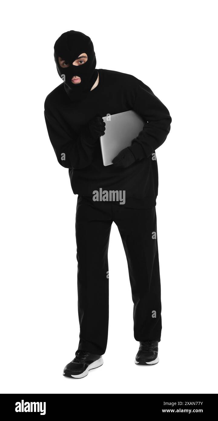 Thief in balaclava sneaking with laptop on white background Stock Photo ...