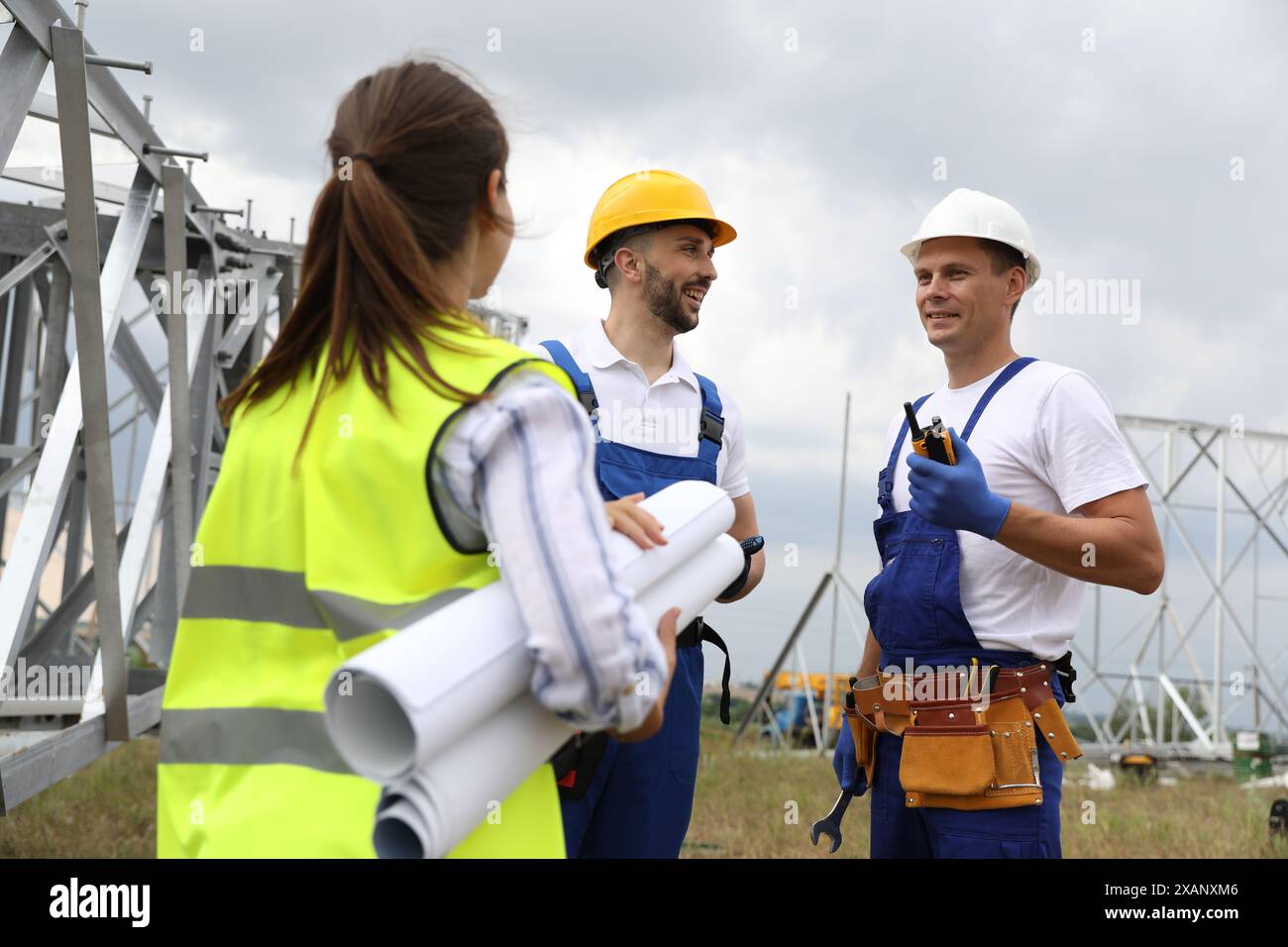 Professional engineers working on installation of electrical substation ...