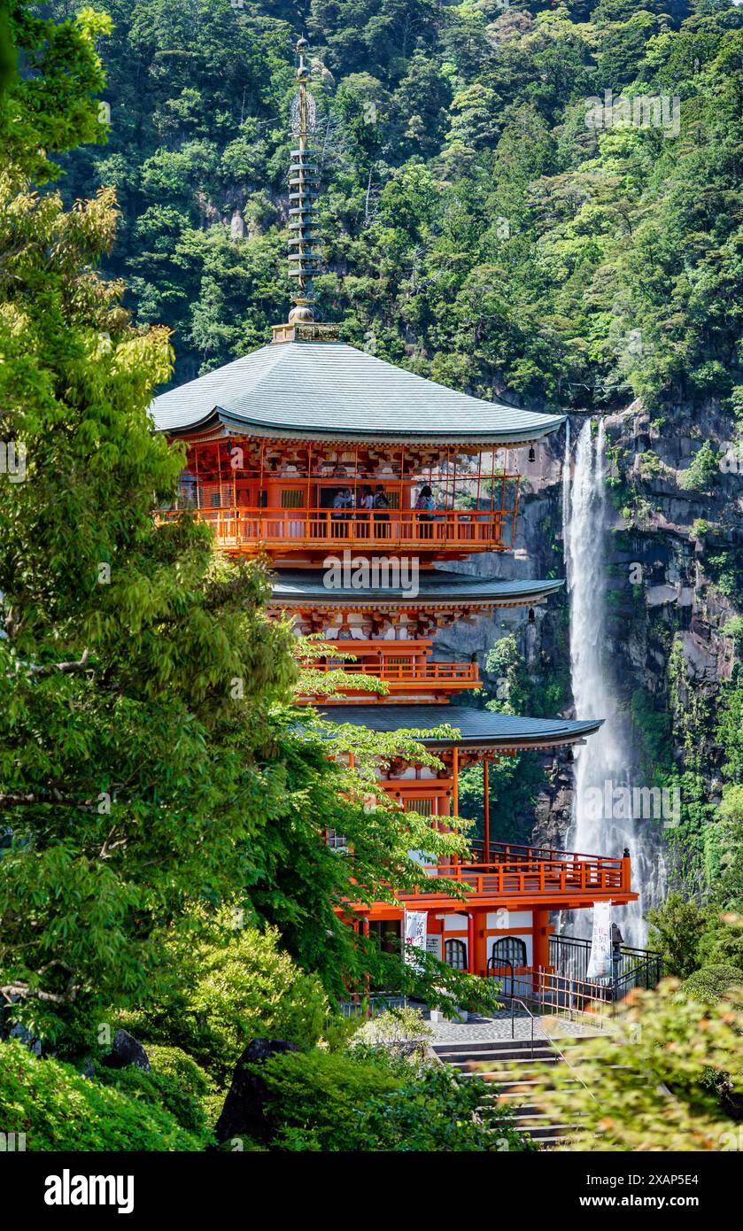 The red three-story pagoda of Seigantoji Buddhist Temple in front of Nachi Falls. Beautiful natural scenery in Nachikatsuura, Japan Stock Photo