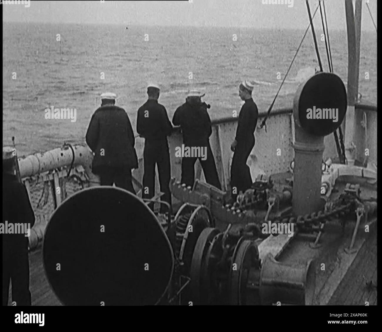 Coast Guard Enforcing Prohibition on Rum Runners, 1929. Prohibition in the USA: sailors firing gun at bootleggers' boat with illegal alcohol. 'It wasn't just a question of sneaking past the customs with the odd bottle, but getting through with a whole shipload. From the five-mile limit in, you were on your own. But there you are - where there's a demand there always has to be a supply. The coast guard held different views, however, and expressed them with force'. From &quot;Time to Remember -  1929 The Time Of The House At Bognor&quot; - Reel 3; a documentary about the world in 1929. Illness o Stock Photo