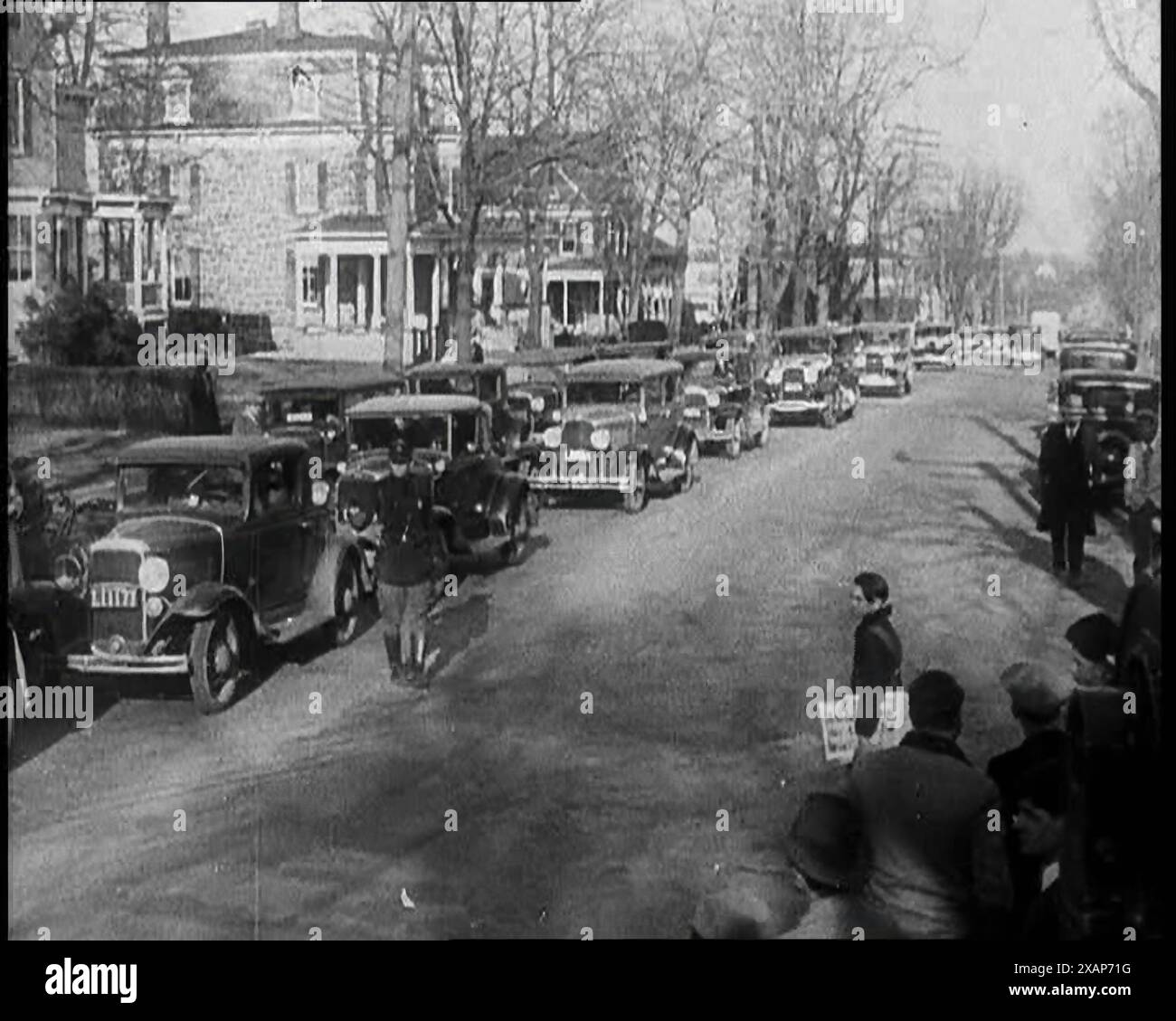 Male American Police Officers on the Streets of New Jersey, 1930s. The Lindbergh Baby kidnapping case of 1932 - &quot;the crime of the century&quot;. The press set up temporary HQ near the site of the abduction. 'All who deal in the written or spoken word communicate with everywhere from Hopewell. The latest goes out from coast to coast'. From &quot;Time To Remember -  The Tough Guys&quot;, 1930s  (Reel 2); documentary film about the 1930s, mainly about life in depression and gangster hit America. Stock Photo