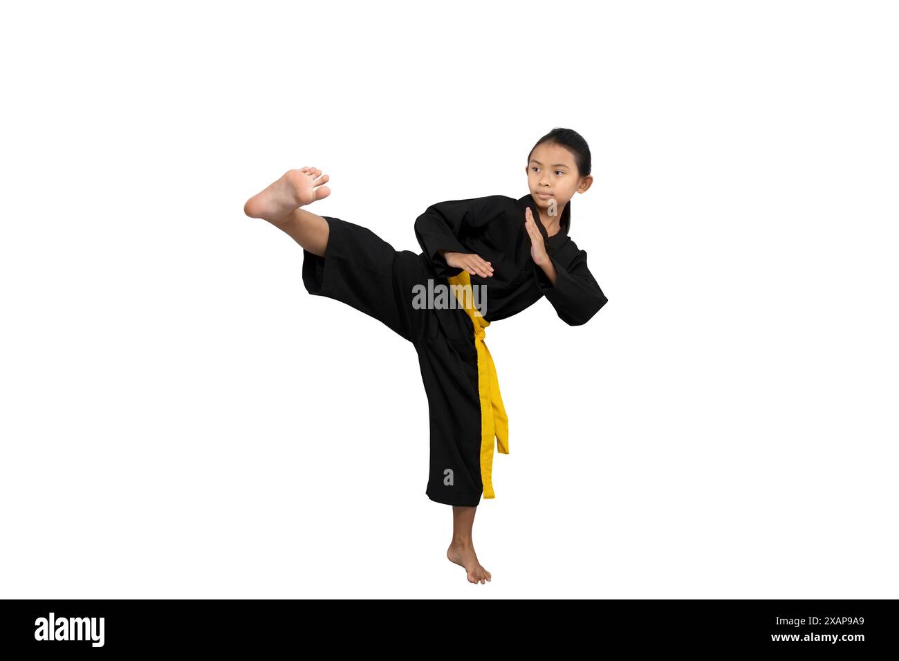 Asian little girl with a yellow sash training martial arts isolated Asian little girl with a yellow sash training martial arts isolated