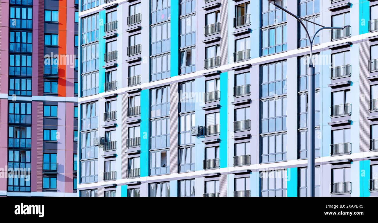 Architectural patterns of modern condos in urban settings. Perfect for real estate investment themes. Showcasing high rise apartments with geometric d Stock Photo