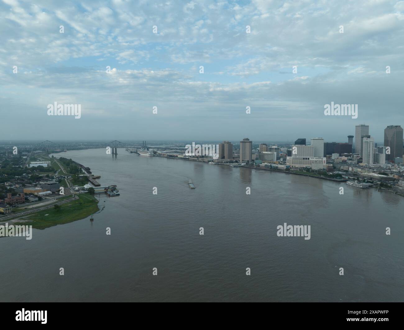 Aerial view of a barge passing by the downtown New Orleans skyline on ...