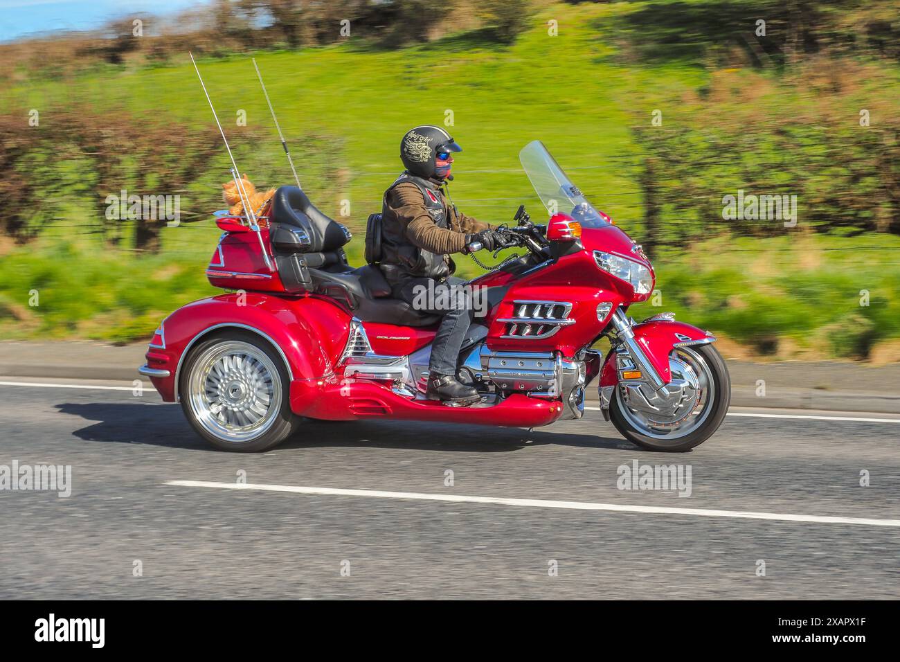 Motorcyclists enjoying their freedom and adventure lifestyle on their economical and low-impact form of transport. Stock Photo
