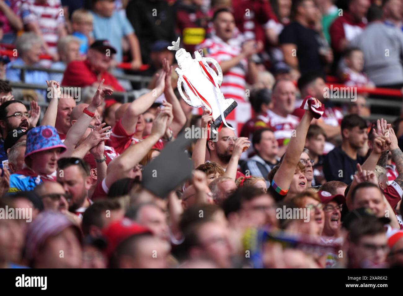 Wigan Warriors fans hold up a cardboard copy of the trophy during the Betfred Challenge Cup final at Wembley Stadium, London. Picture date: Saturday June 8, 2024. Stock Photo