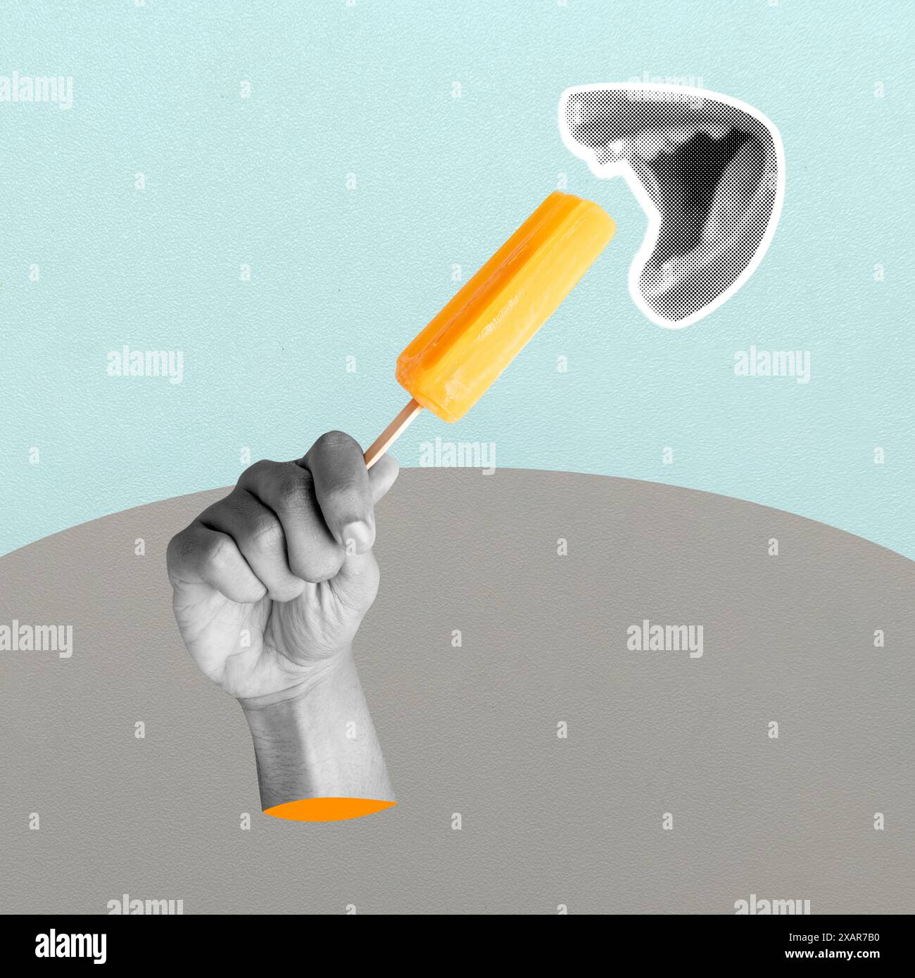 A hand holding a yellow ice cream stick with a black and white background. The image has a playful and fun mood Stock Photo