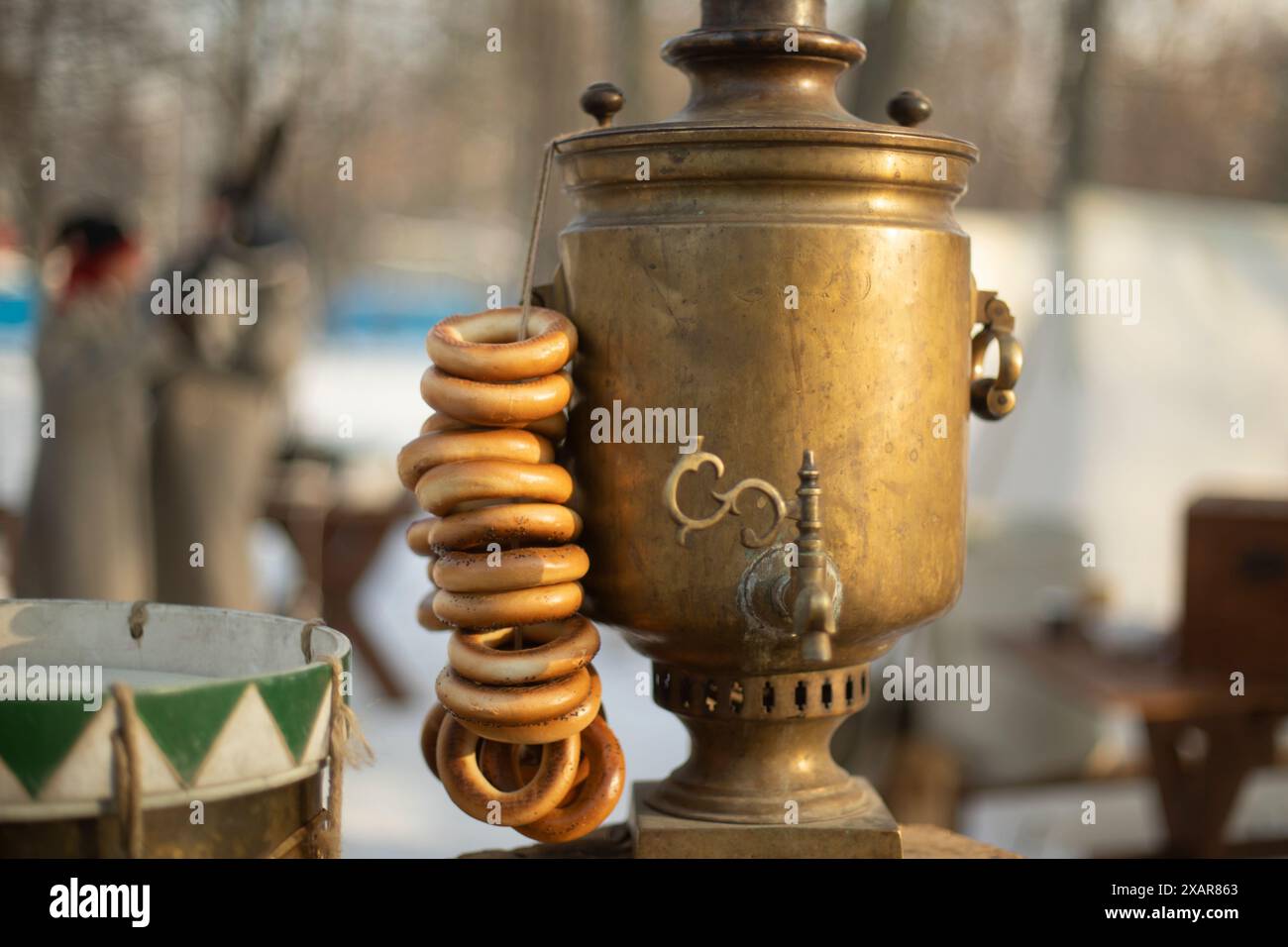 Russian tea in winter. Samovar on street. Bagels and samovar ...
