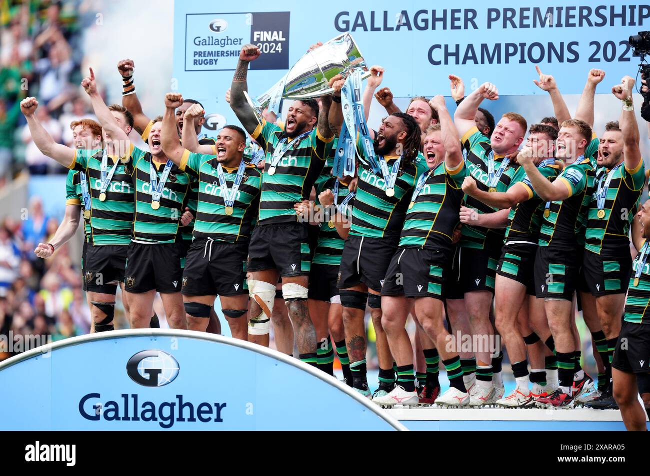 Northampton Saints players celebrate on the pitch with the trophy after winning the Gallagher Premiership final at Twickenham Stadium, London. Picture date: Saturday June 8, 2024. Stock Photo