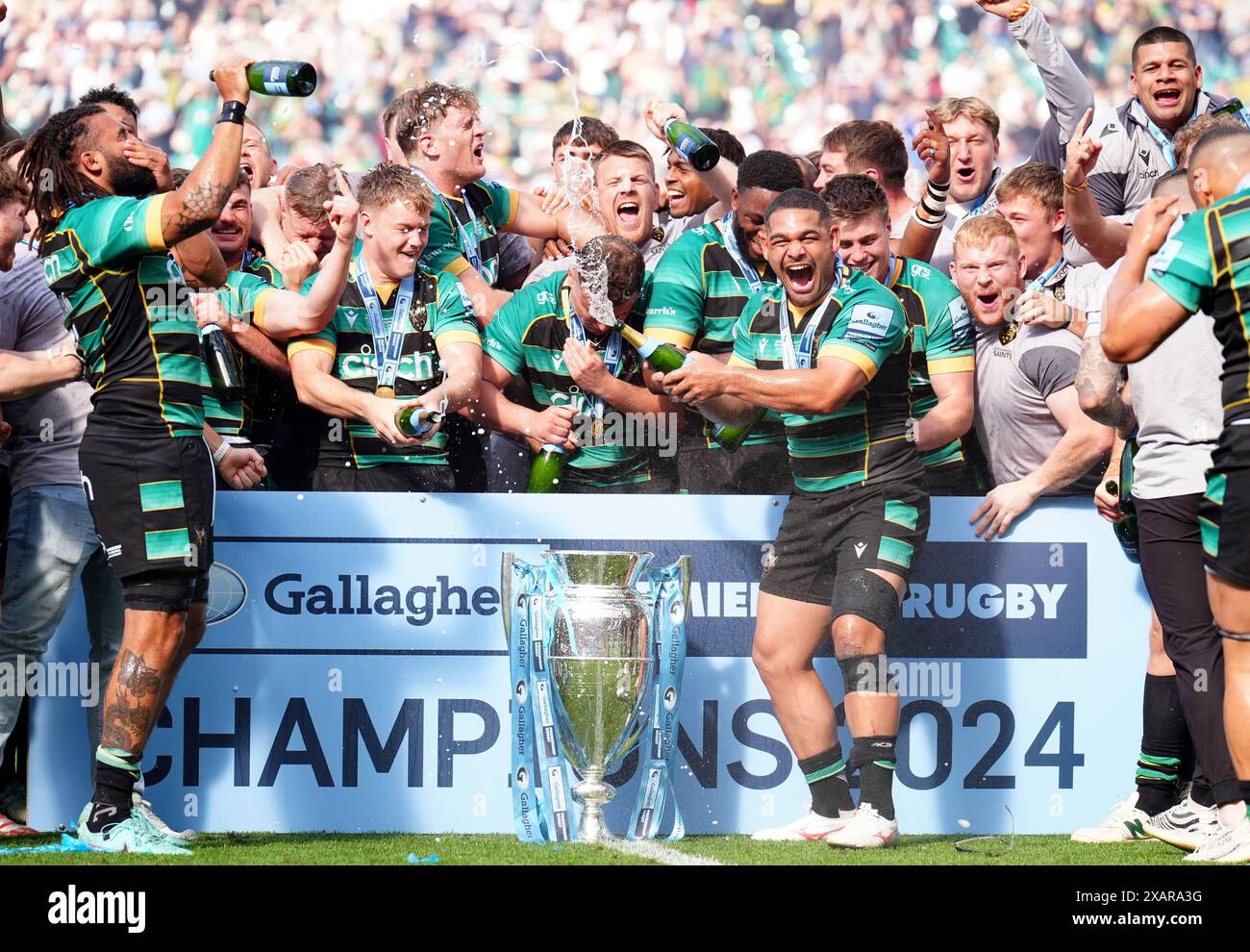 Northampton Saints Players Celebrate On The Pitch With The Trophy After northampton-saints-players-celebrate-on-the-pitch-with-the-trophy-after