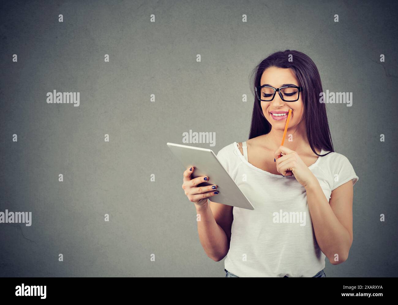 Woman Browsing Computer Cute happy woman browsing internet on her tablet computer Stock Photo ...