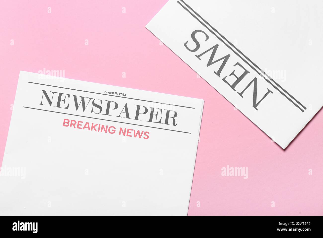 Blank newspapers on pink background Stock Photo
