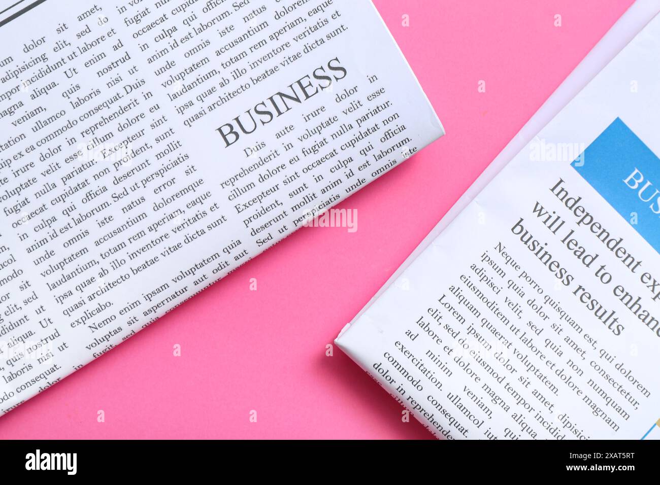 Different newspapers on pink background Stock Photo