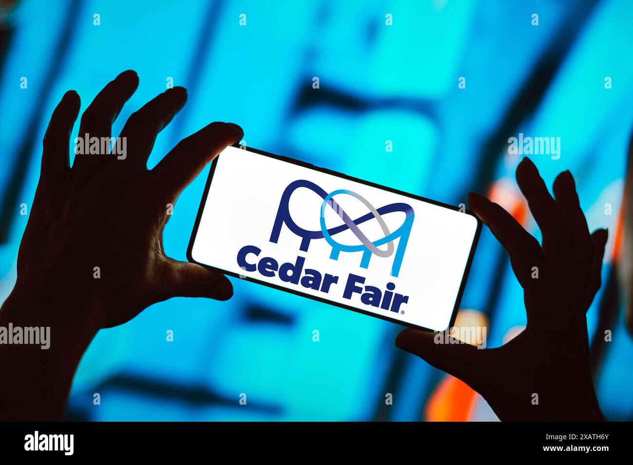 In this photo illustration, the Cedar Fair Entertainment Company logo is displayed on a smartphone screen. Stock Photo