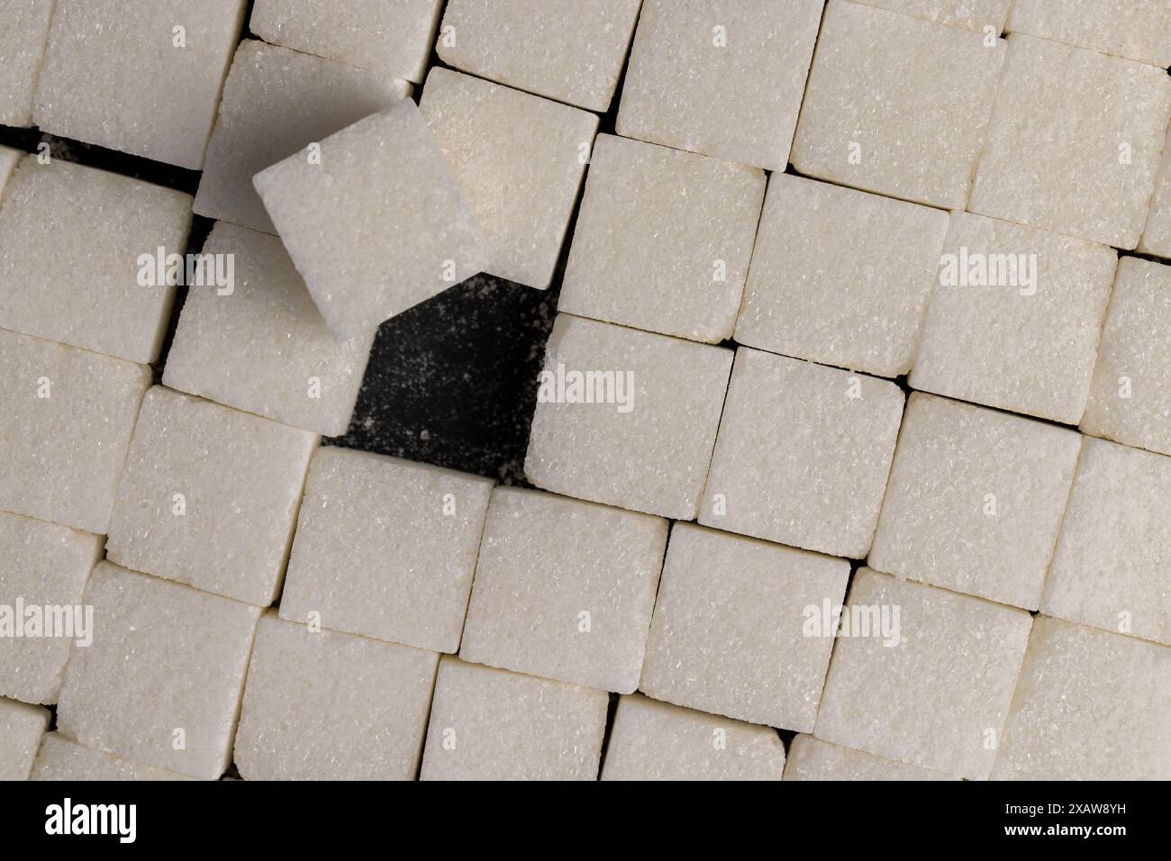 white square sugar on a black background , lump sugar in the shape of a ...