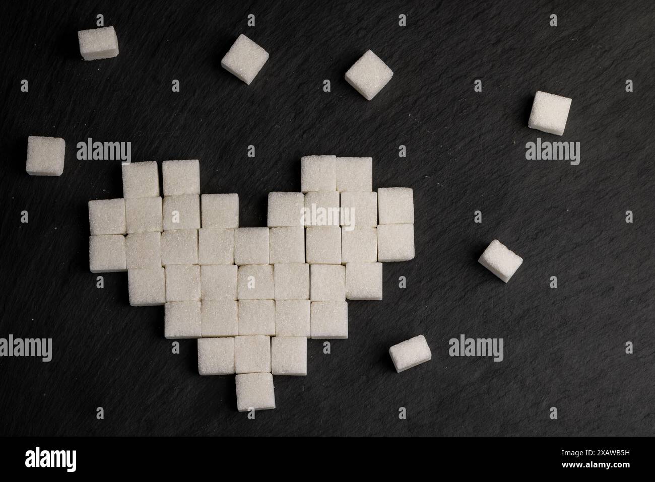 white square sugar on a black background , lump sugar in the shape of a ...