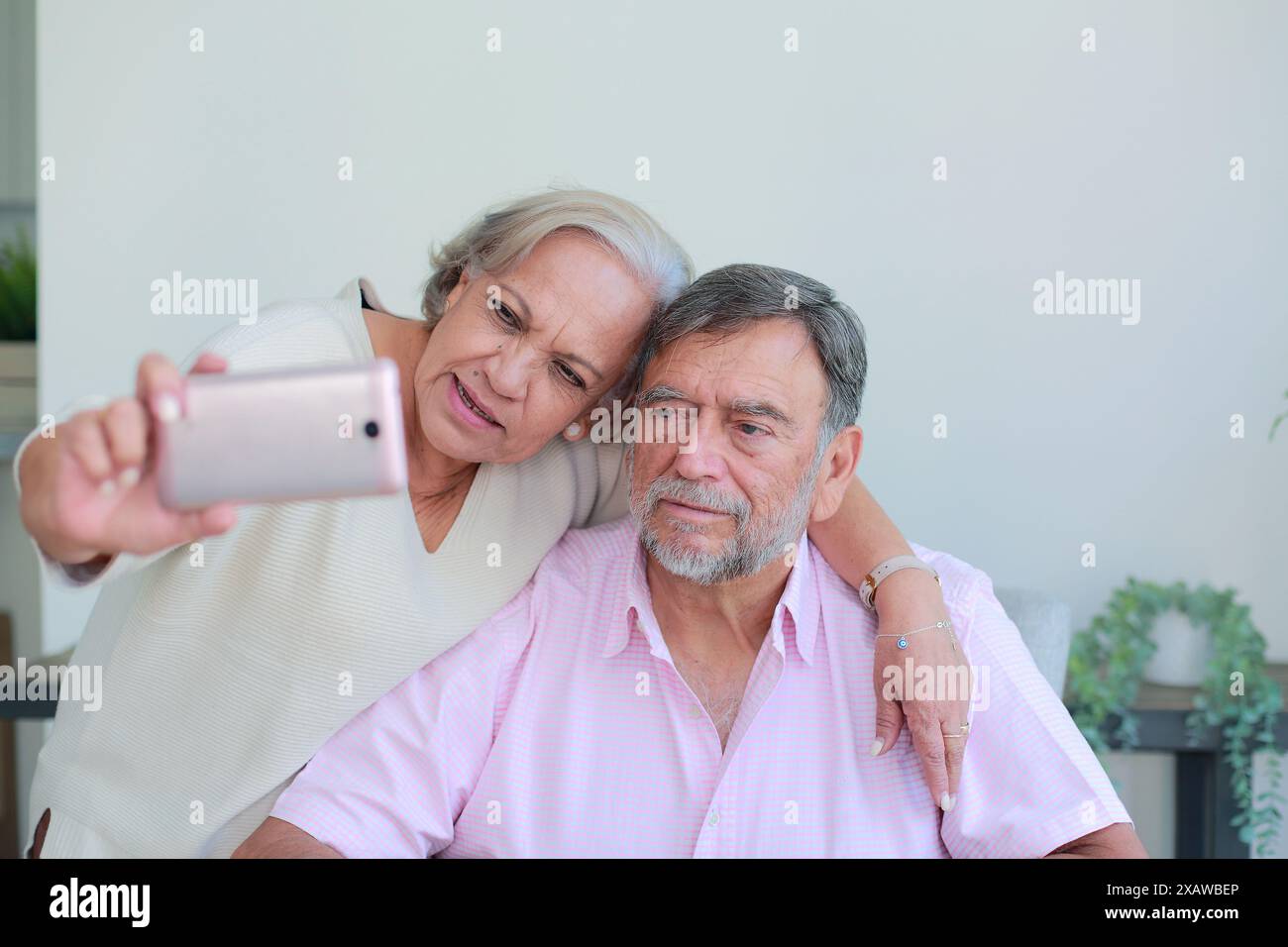 Older couple take a selfie with cell phone sitting at home Stock Photo ...