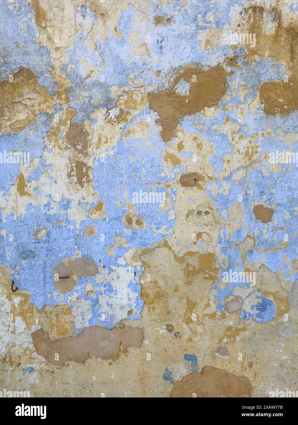 Peeling paint on wall. Scratched painted surface. colorful grunge cracked paint wall background. layers of paint weathered concrete textures. Old weat Stock Photo