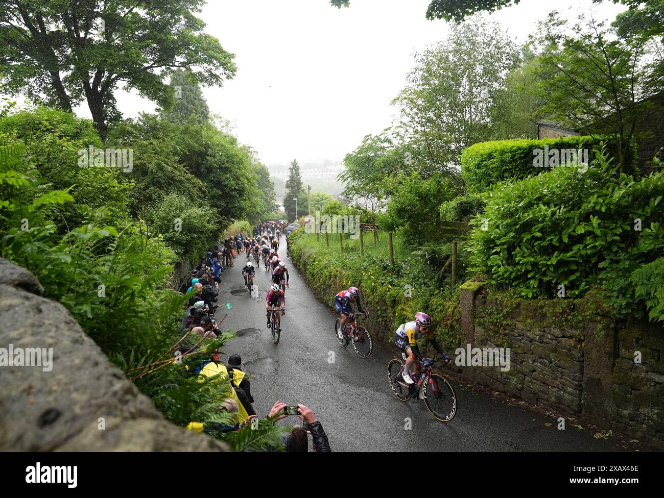 Riders heading up The Rake hill climb in Ramsbottom during stage four ...