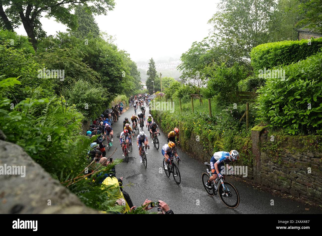 Riders heading up The Rake hill climb in Ramsbottom during stage four ...