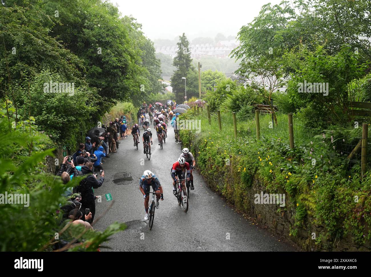Riders heading up The Rake hill climb in Ramsbottom during stage four ...