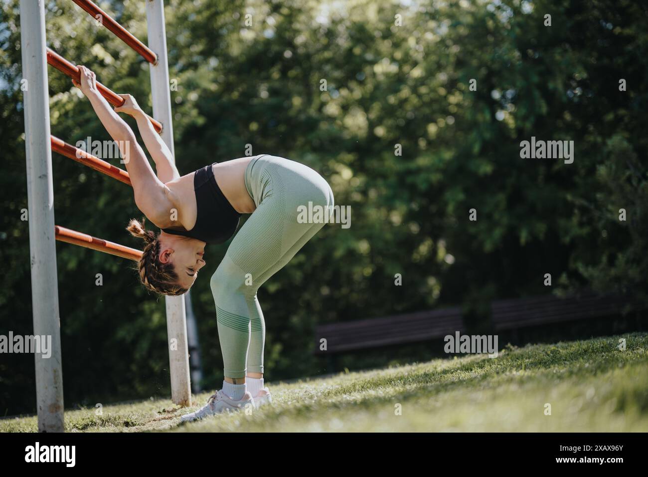 young-woman-performing-calisthenics-exercises-in-urban-park-on-a-sunny