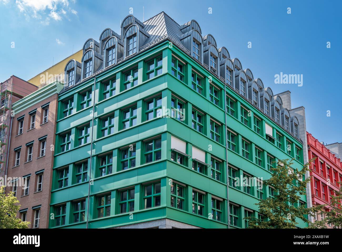 Curated visual reference: Tall Green Buildings With Apartment Living And Shopping Reference: Surrounded By Residential And Office Buildings Hi Res Stock Photography
