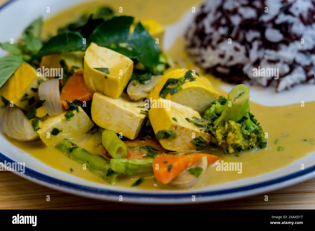 Traditional vegetable green curry with herbs and steamed rice Stock ...