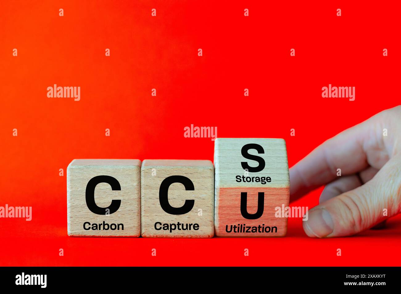 The CCSU symbol for carbon capture and utilization during storage. Hand-rotating wooden cubes with the words CCS on CCSU.Net Zero Action concept. gree Stock Photo