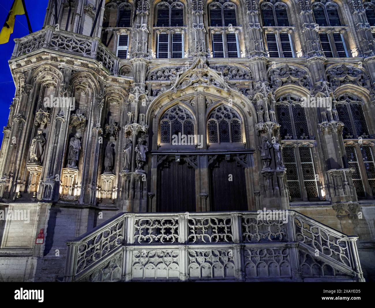 Detailed Gothic entrance facade of a historic building at night, Ghent ...