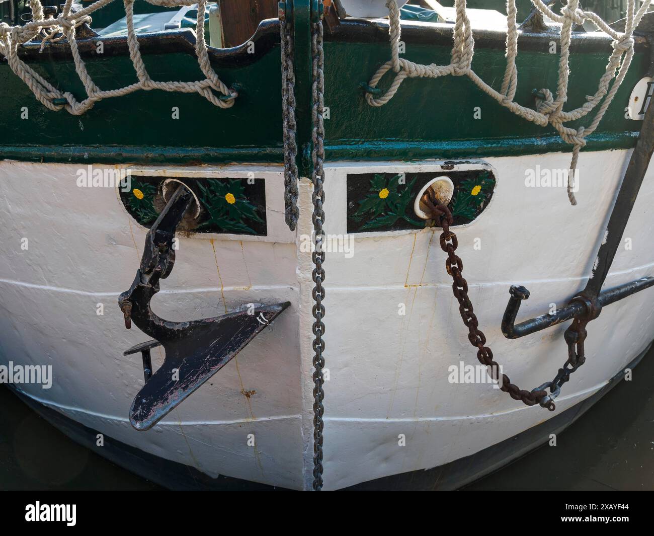 Close-up of a boat bow with anchor, chains and rope. Maritime ...