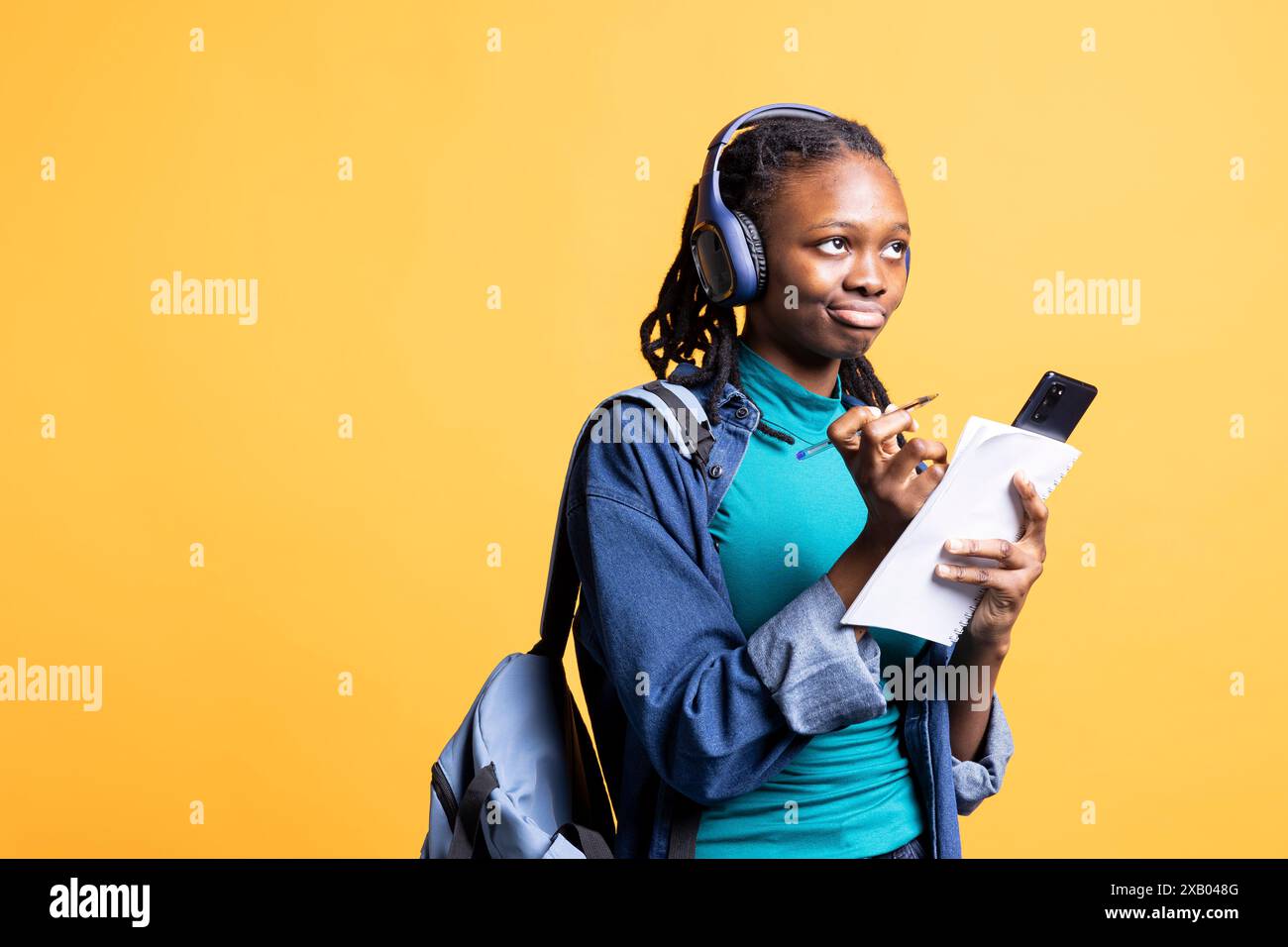BIPOC student thinking how to solve homework exercises while listening ...