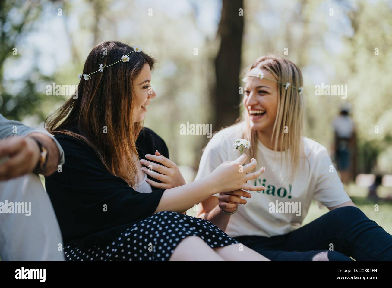 Joyful friends enjoying a sunny day together in the park, multicultural ...