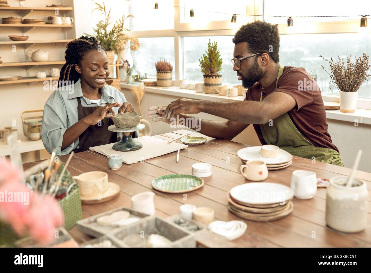 Two people looking involved while working with new pottery Stock Photo ...