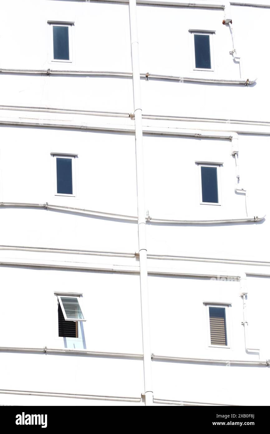 Windows of an apartment building on a white wall for your concept background design Stock Photo