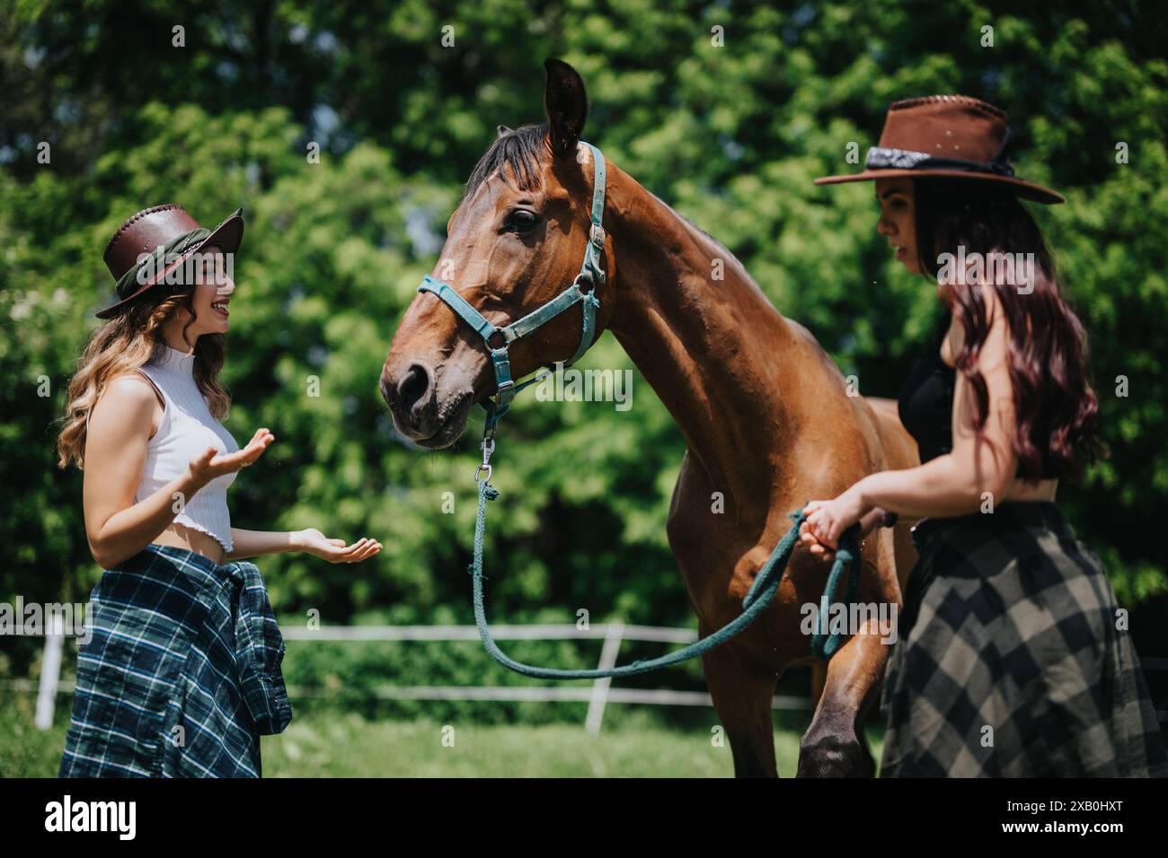 Two women having fun at the ranch with horse, enjoying countryside life ...