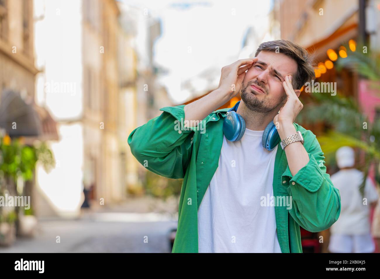 Displeased exhausted Caucasian man rubbing temples to cure headache ...