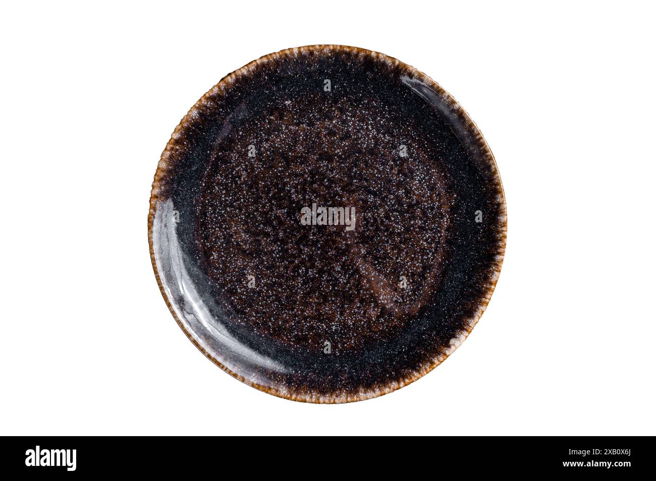 Empty black craft plate on table. Table setting. Isolated on white background. Stock Photo