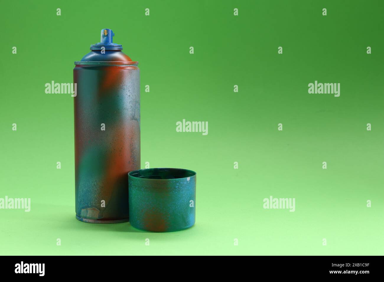 Spray paint can with cap on green background, space for text Stock Photo