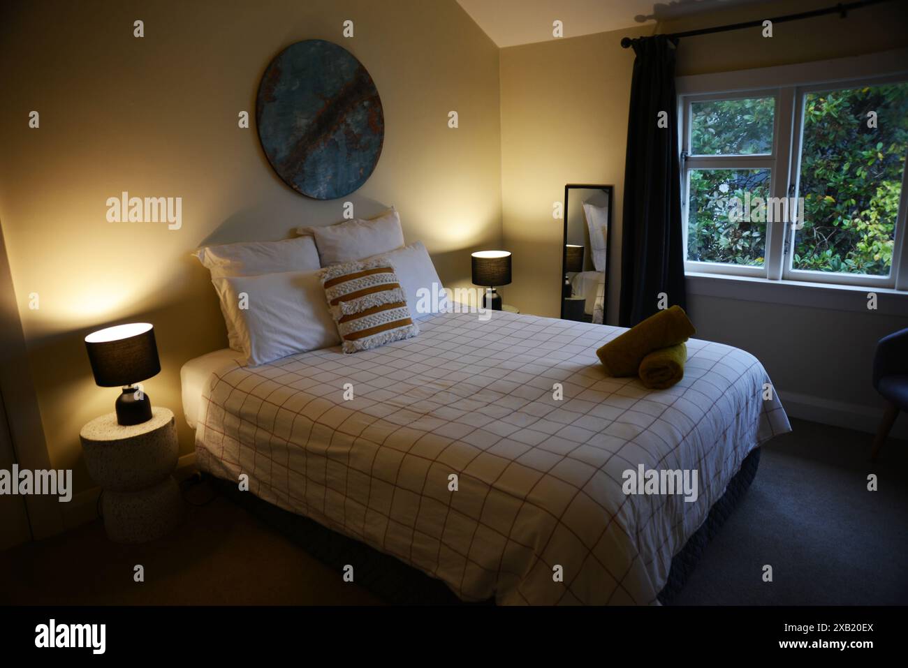 Interior of a retro bedroom with a double bed and bedside cabinets Stock Photo