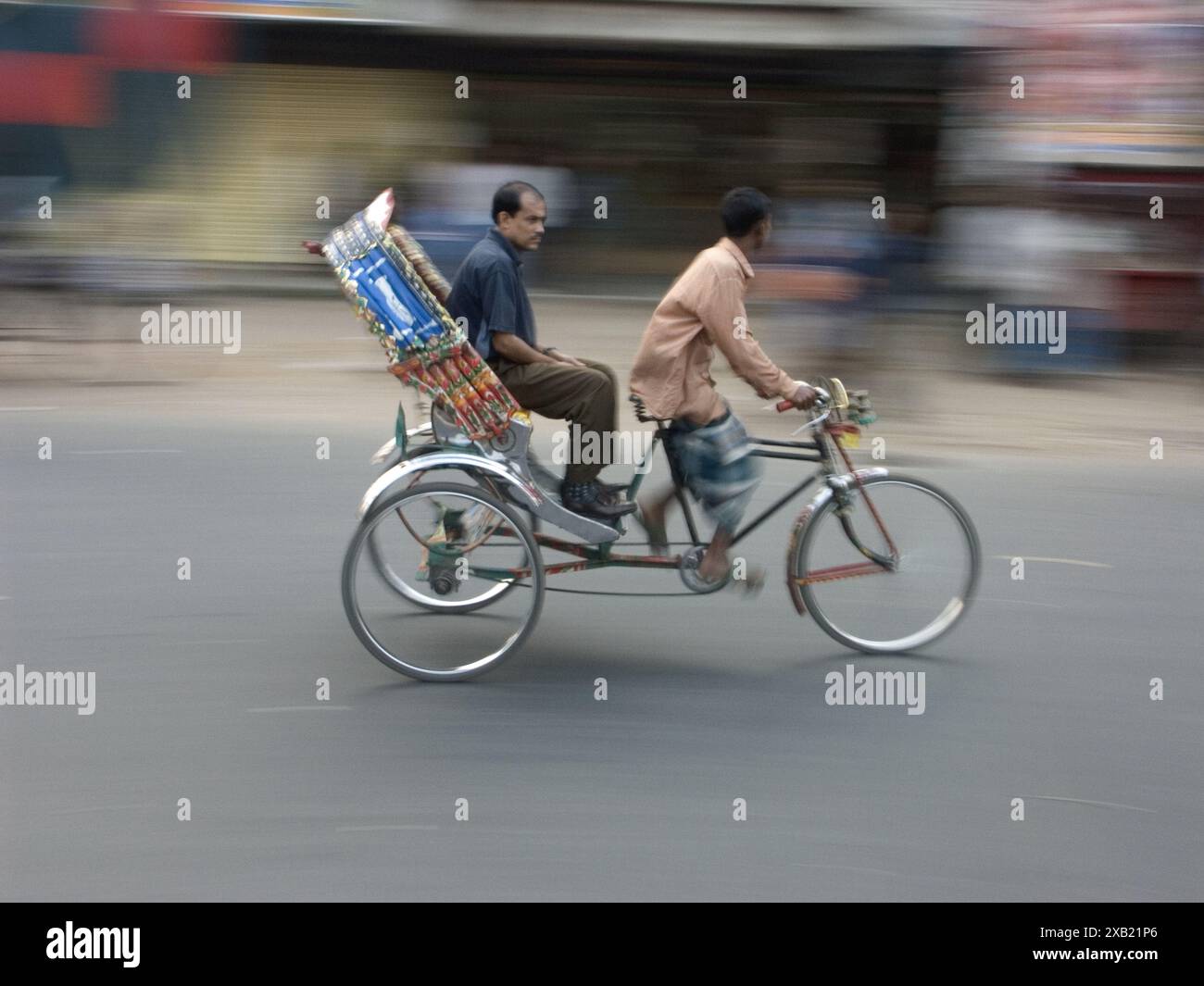 A passenger travels on a bicycle rickshaw, Bangladesh, Asia. (Motion ...