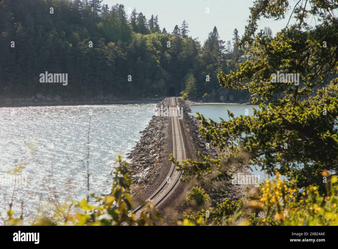 Railroad tracks crossing Chuckanut Bay and headed towards Bellingham Stock Photo