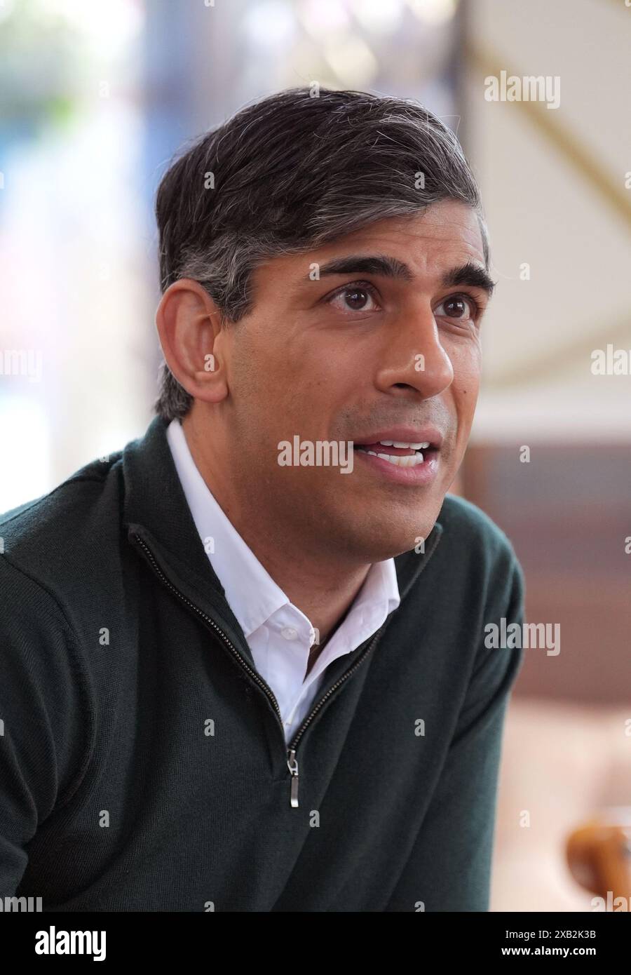 Prime Minister Rishi Sunak talking to locals at a cafe in Squires Garden Centre in Crawley, West