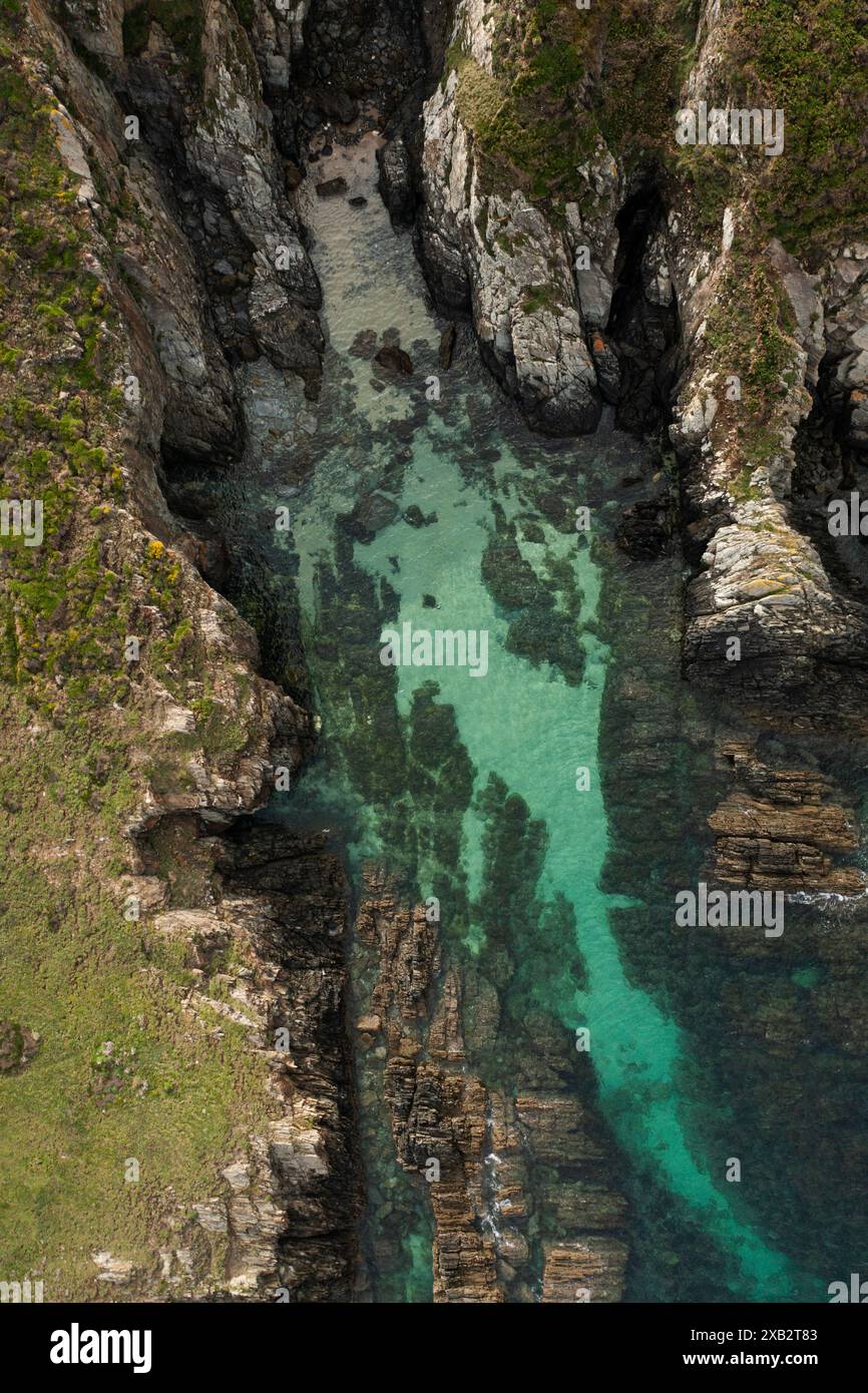 An aerial shot capturing the tranquil beauty of a narrow sea inlet ...