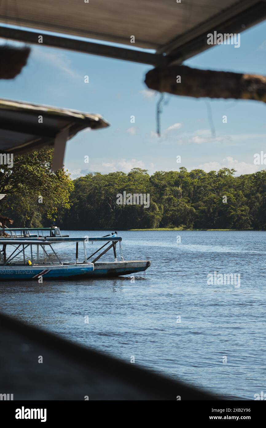 Serene scene of tour boats docked on a tranquil Costa Rican river ...