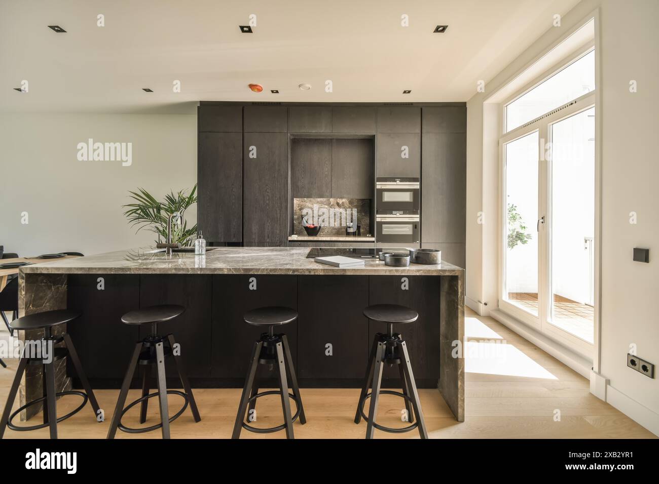 Elegant modern kitchen interior featuring a sleek marble countertop ...